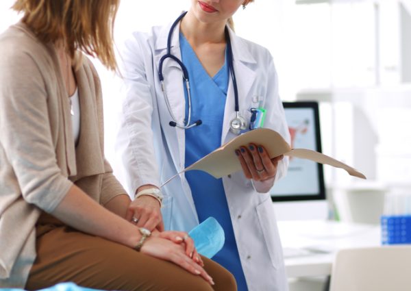 Doctor,And,Patient,Discussing,Something,While,Sitting,At,The,Table